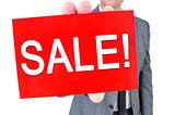 man in suit with a signboard with the text sale
