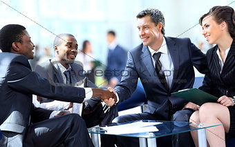 Satisfied proud business team looking at camera and smiling in office