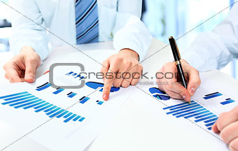 Close-up of business people working with documentation