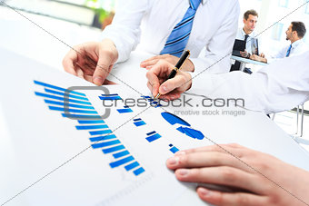 Close-up of business people working with documentation