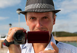 man in a hat with a camera