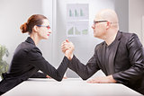 woman vs man business arm wrestling