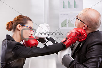 woman punching a man on the face in a box match
