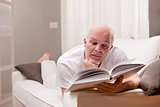 man reading a book on the sofa