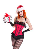 Beautiful pinup girl in red corset and Santa Claus hat, holding 