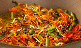 Asian noodles with vegetables on wok