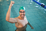 Portrait of a fit swimmer cheering in the pool
