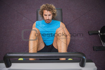 Handsome man doing leg presses in gym