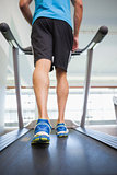 Low section of a man running on treadmill