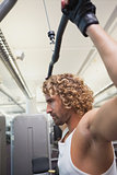 Man exercising on a lat machine in gym