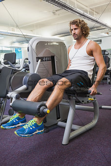 Young man doing leg workout at gym