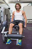 Handsome man doing leg workout at gym