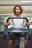 Man working out on exercise bike at gym