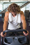 Man working out on exercise bike at gym