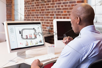 Businessman looking at computer monitor in office