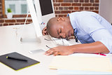 Businessman resting head on computer keyboard