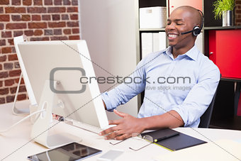 Cheerful businessman using computer in office