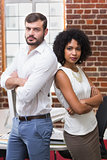 Confident business people with arms crossed in office