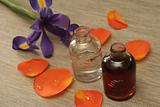 Two bottles with oil and an orange rose