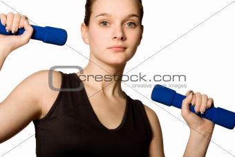 Young girl is holding the weights