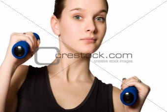 Young girl posing with weights