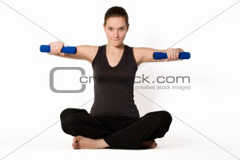 Young girl is holding balance with weights