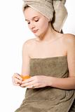 girl in towel peeling a mandarin