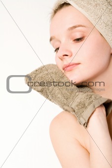 Young woman is cleaning her face