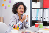 Female interior designer with coffee cup at desk