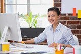 Smiling young woman working at desk