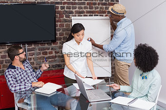 Casual businessman giving presentation to colleagues