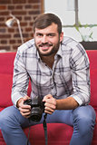 Portrait of casual photo editor holding camera