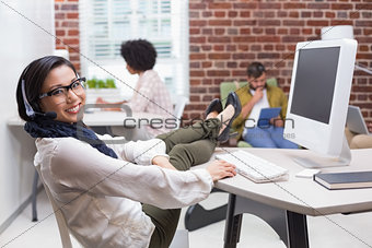 Smiling casual woman using computer