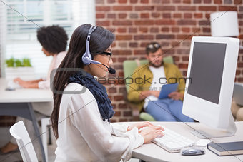 Concentrated casual young woman using computer