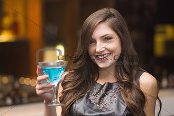 Pretty brunette holding a cocktail