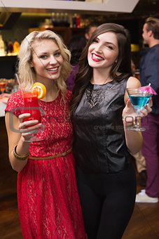Pretty friends drinking a cocktail