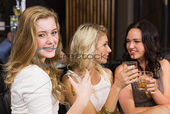 Pretty friends having a drink together