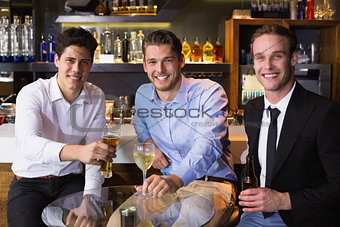 Handsome friends having a drink together