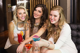Pretty friends drinking cocktails together