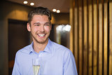 Handsome man holding flute of champagne
