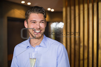 Handsome man holding flute of champagne