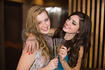 Attractive friends toasting with champagne