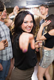 Stylish brunette smiling and dancing