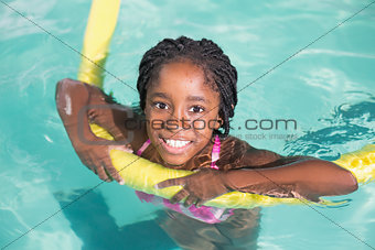 Cute little girl swimming in the pool