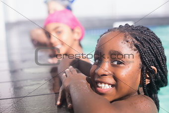 Cute little kids swimming in the pool