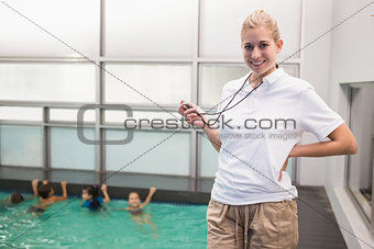 Pretty swimming coach smiling at camera