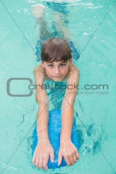 Cute little boy learning to swim