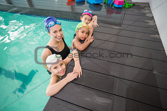 Cute swimming class and coach smiling
