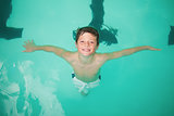 Cute little boy smiling in the pool
