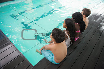 Cute little kids sitting poolside